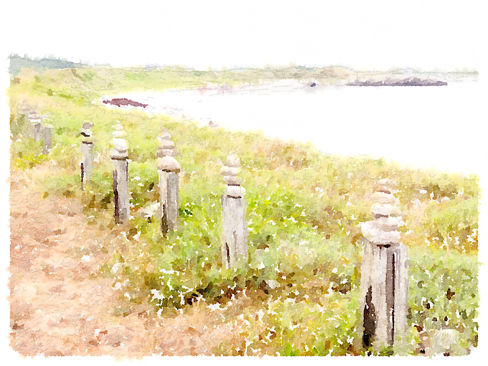 Small stones piled on wooden poles - Bryher